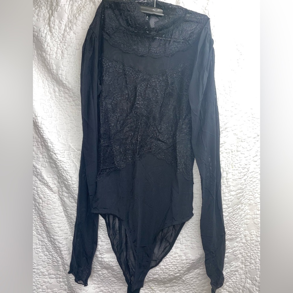 Black lace bodysuit with high neck.